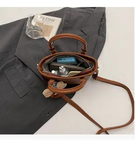 Top view of caramel leather handbag interior showing storage space and zipper detail