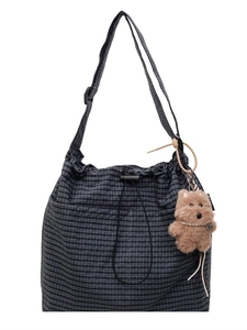 Minimalist navy plaid drawstring bucket bag with a cute plush puppy charm and strap