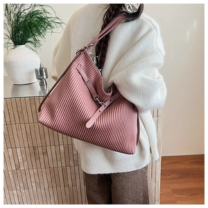 Detail of light pink pleated tote bag featuring large capacity and stylish metal buckle