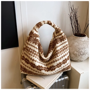 Detail of soft brown and beige plush tote bag with wool-like texture on a stylish background