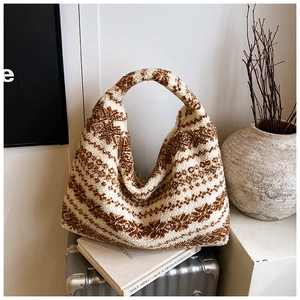 Detailed close-up of fluffy faux fur tote bag with brown and white geometric stripes