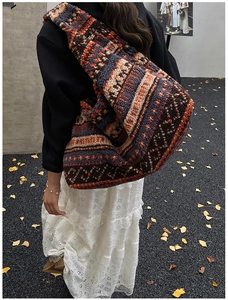 Detail of ethnic pattern on oversized faux shearling tote bag with wide strap