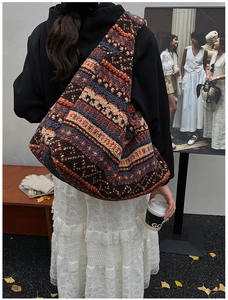 Bohemian plush hobo bag with ethnic knit patterns shown in an autumn street style view