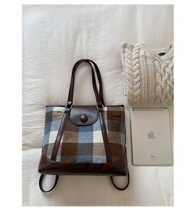 Detail shot of vintage plaid tote bag showing its large capacity and faux leather trim
