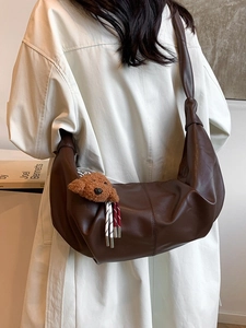 Dark brown crescent crossbody bag in soft PU leather with cute teddy bear charm