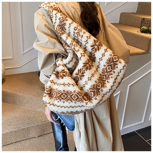 Detailed view of the large plush tote bag with geometric jacquard pattern on a model