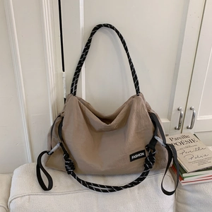 Detail of khaki large capacity nylon tote bag with braided rope shoulder straps