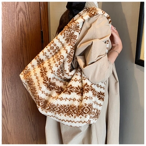 Detail of plush lamb wool tote bag featuring brown and white ethnic pattern embroidery
