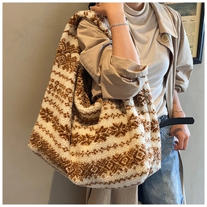 Detail of plush tote bag with brown and white snowflake pattern on faux fur material