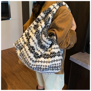 Close-up of oversized black and white plush tote bag in soft fleece material