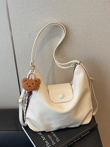 Chic beige hobo shoulder bag with cute bear pendant and fashion embossed logo