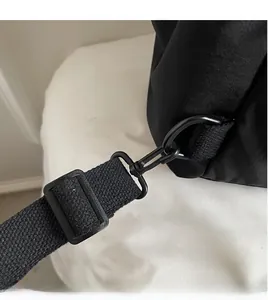 Detail of durable black metal D-ring hook attached to high-density woven backpack strap