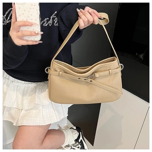 Detailed view of khaki pleated texture shoulder bag with slim strap and metal buckle