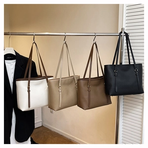 Detail of minimalist tote bags in four colors with pebble grain leather texture