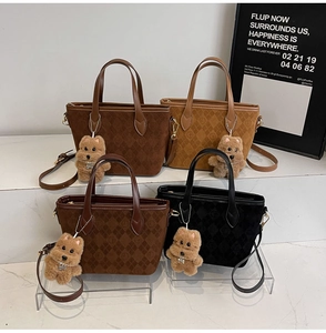 Detail of vintage matte tote bags in four colors with cute plush bear charms