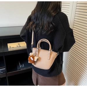 Chic light brown bucket bag with lychee texture and cute lion plush charm