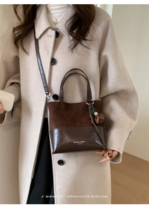 Detail of vintage brown patchwork crossbody bucket bag on beige wool coat outfit