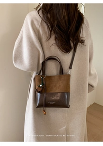 Detail of minimalist retro bucket bag with suede leopard pattern and leather stitching