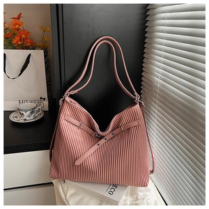 Detail of pink pleated texture and decorative front buckle on a soft shoulder tote bag