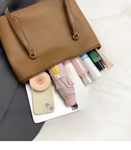 Top-down macro view of brown leather tote bag interior showing spacious capacity for daily items