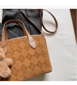 Detailed close-up of brown vintage monogram bucket bag with plush bear charm accessory