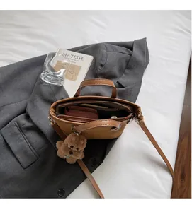 Interior view of brown leather bucket bag showing large capacity and internal pockets