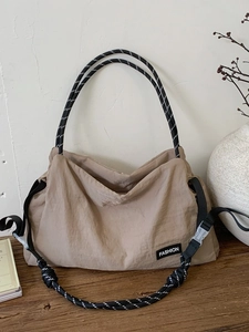 Khaki large capacity nylon tote bag with black and white woven rope shoulder straps