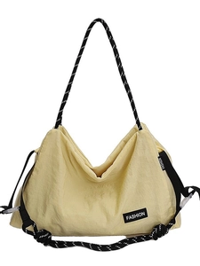 Yellow large capacity nylon tote bag with black and white rope strap and fashion label