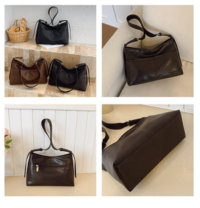 Detailed back view of a soft leather tote bag featuring a secure zipper pocket and shoulder strap