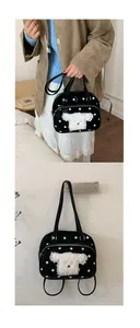 Detail of black polka dot tote bag featuring a cute white plush puppy patch embroidery