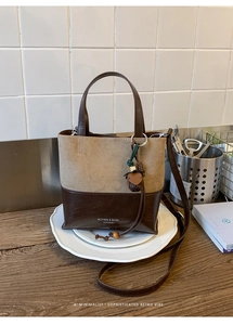 Close-up of retro two-tone tote bag with a khaki matte and dark brown glossy finish
