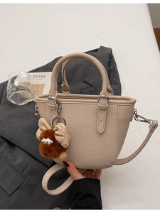 Chic beige lychee grain tote bag for women with removable strap and plush charm