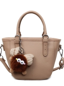 Khaki pebbled leather handbag with twin handles and a cute monster plush keychain
