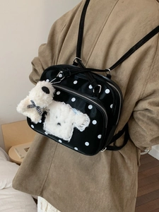 Cute black polka dot backpack with plush puppy charm for students and commuting