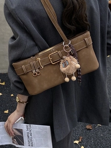Vintage brown suede shoulder bag with belt buckle detail and cute plush charm