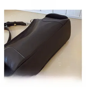 Gros plan des coutures renforcées et des ferrures de ce grand sac cabas en cuir marron