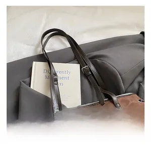 Detail shot of the dark leopard print leather texture and metal buckle on the shoulder bag