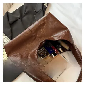 Spacious interior of a dark brown oil-wax leather tote bag showing large capacity storage