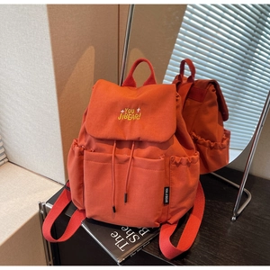 Close-up of orange casual backpack featuring YOU JIBEAR embroidery and drawstring flap cover