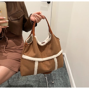 Detail of vintage brown suede tote with white shearling trim and smooth leather handles