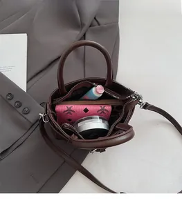 Top view of compact brown crossbody bag interior showing spacious storage for daily items