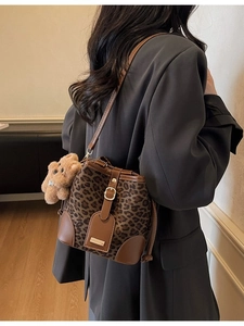 Vintage leopard print bucket bag with brown leather trim and cute bear plush charm