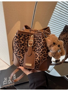 Retro leopard print bucket bag with brown leather trim and cute plush puppy charm