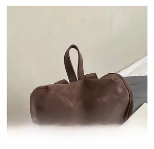 Close-up of the reinforced brown leather handle on a large vintage travel backpack