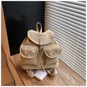 Detail view of beige velvet backpack with vintage flap cover and dual front button pockets