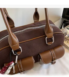 Détail du sac Boston vintage marron avec surpiqûres blanches et design à plusieurs poches