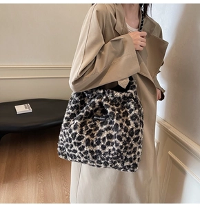 Detail of plush leopard print tote bag with Moonshine label on faux fur texture