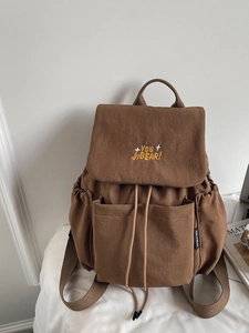Minimalist large capacity backpack in dark brown featuring front flap and embroidery