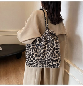 Detail of plush leopard print tote bag with drawstring closure and spotted rope strap