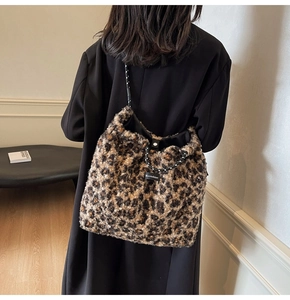 Plush leopard print tote bag with woven shoulder strap and Moonshine brand label detail